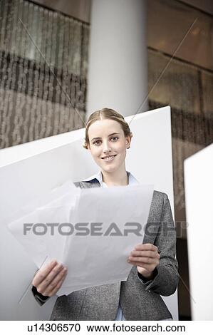 Businesswoman looking at paperwork View Large Photo Image Stock Image - Businesswoman looking at paperwork. Fotosearch