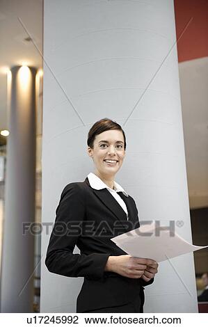 Businesswoman looking at paperwork View Large Photo Image Stock Image - Businesswoman looking at paperwork. Fotosearch