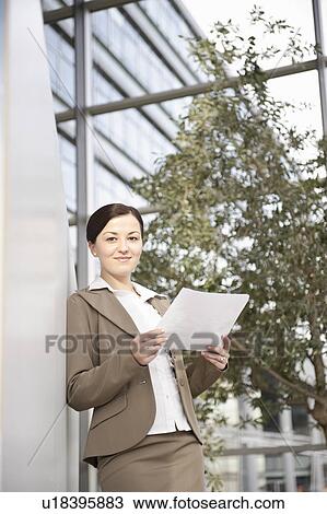 Businesswoman looking at paperwork View Large Photo Image Stock Image - Businesswoman looking at paperwork. Fotosearch