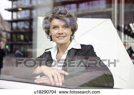 Businesswoman looking out of the window View Large Photo Image Picture - Businesswoman looking out of the window. Fotosearch