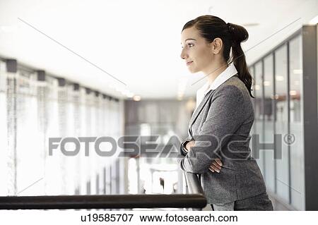 Businesswoman looking out window View Large Photo Image Stock Photo - Businesswoman looking out window. Fotosearch