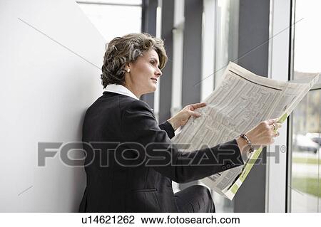 Businesswoman reading newspaper View Large Photo Image Stock Image - Businesswoman reading newspaper. Fotosearch