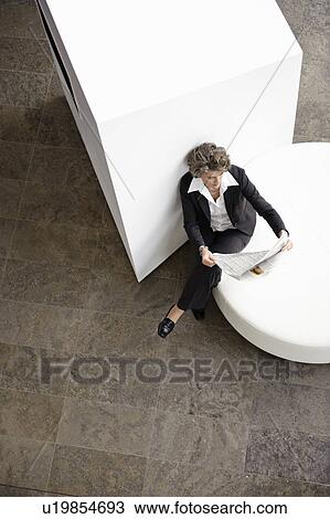 Businesswoman reading newspaper View Large Photo Image Stock Image - Businesswoman reading newspaper. Fotosearch