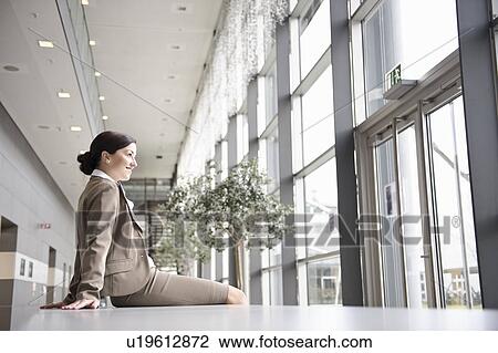 Businesswoman relaxing in office View Large Photo Image Stock Image - Businesswoman relaxing in office. Fotosearch