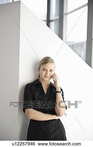 Stock Photograph - Businesswoman using cell phone. Fotosearch