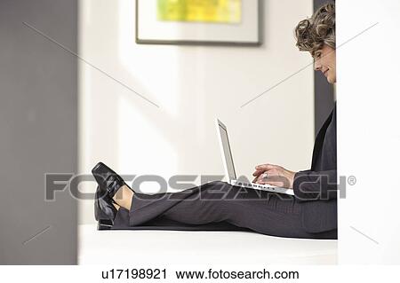Stock Image - Businesswoman using laptop. Fotosearch