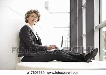 Stock Photo - Businesswoman using laptop. Fotosearch