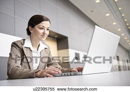 Businesswoman using laptop View Large Photo Image Stock Photography - Businesswoman using laptop. Fotosearch