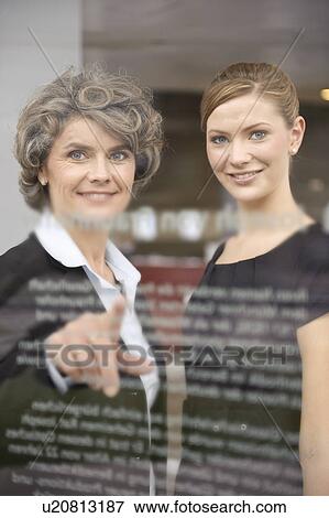 Stock Photo - Businesswoman writing on glass. Fotosearch