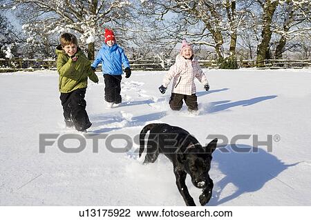 Children and dog running in the snow View Large Photo Image Stock Image - Children and dog running in the snow. Fotosearch