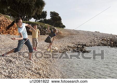Stock Image - Children at the beach. Fotosearch