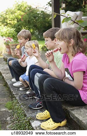 Children enjoying popsicle outdoors View Large Photo Image Stock Photo - Children enjoying popsicle outdoors. Fotosearch