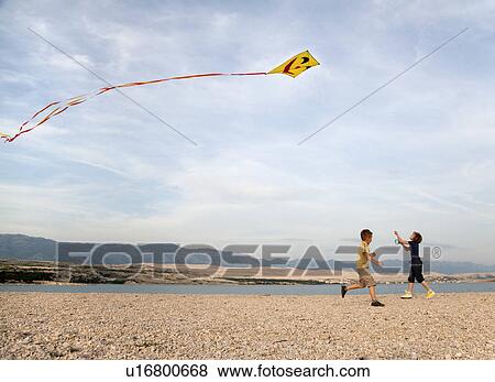 Children flying kite at beach View Large Photo Image Stock Photo - Children flying kite at beach. Fotosearch
