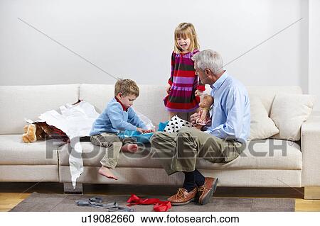 Children opening presents with granddad View Large Photo Image Stock Image - Children opening presents with granddad. Fotosearch