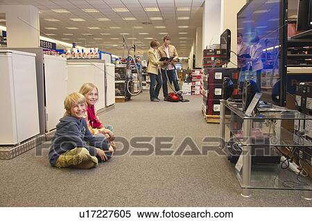 Children passing time by watching TV View Large Photo Image Stock Photography - Children passing time by watching TV. Fotosearch