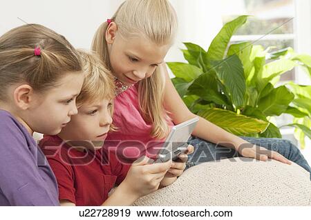 Children playing a game on a console View Large Photo Image Stock Photo - Children playing a game on a console. Fotosearch