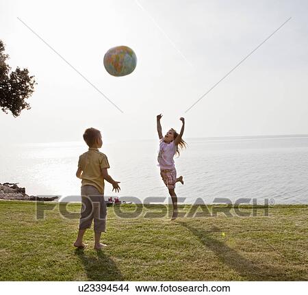 Picture - Children playing ball at the beach. Fotosearch