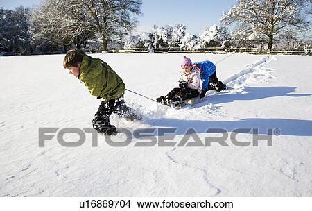 Children playing on sledge in the snow View Large Photo Image Picture - Children playing on sledge in the snow. Fotosearch