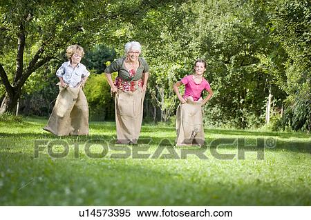 Children sack racing with grandmother View Large Photo Image Stock Photography - Children sack racing with grandmother. Fotosearch