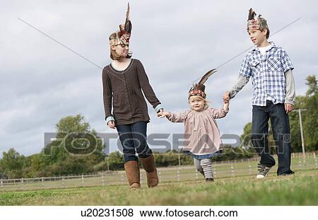 Children walking hand in hand View Large Photo Image Stock Photo - Children walking hand in hand. Fotosearch