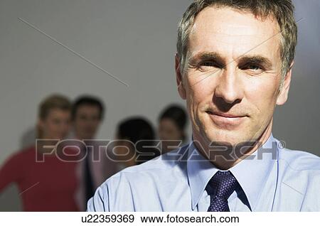 Confident business man looks to camera View Large Photo Image Stock Photo - Confident business man looks to camera. Fotosearch