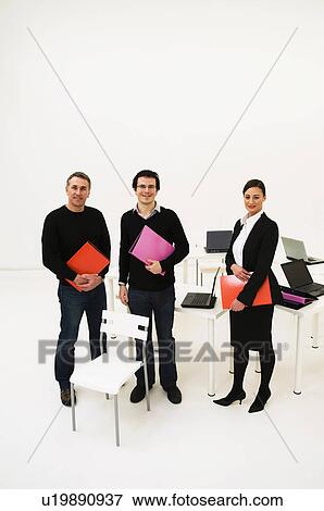 Confident business people in office View Large Photo Image Stock Photo - Confident business people in office. Fotosearch