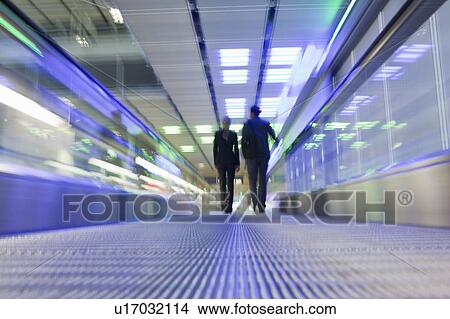 conveyor belt with couple in background View Large Photo Image Picture - conveyor belt with couple in background. Fotosearch