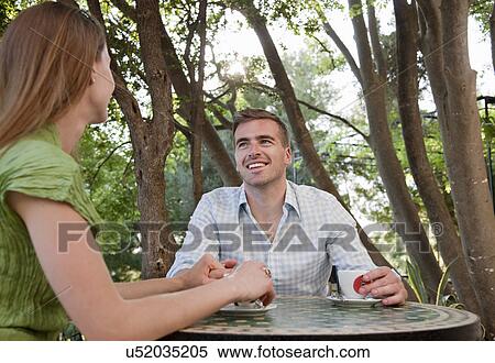 Couple at cafe holding hands View Large Photo Image Stock Photography - Couple at cafe holding hands. Fotosearch
