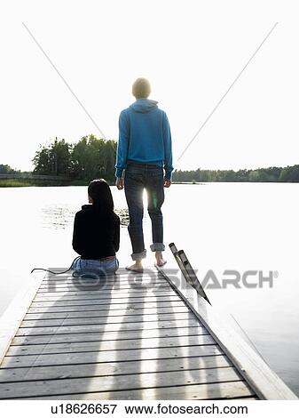 Stock Photo - Couple at the end of a dock. Fotosearch