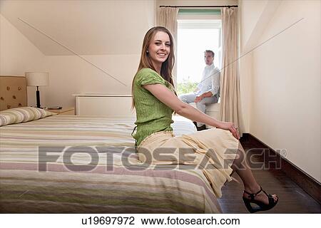 Stock Image - Couple in hotel room. Fotosearch
