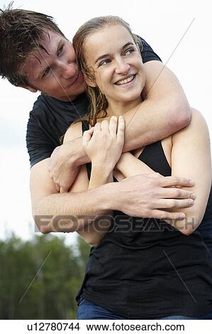 Couple in wet clothes hugging each other View Large Photo Image Picture - Couple in wet clothes hugging each other. Fotosearch