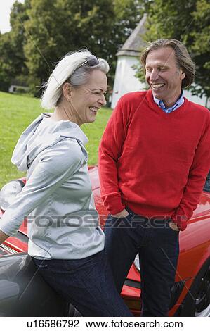 Couple laughing outdoors View Large Photo Image Stock Image - Couple laughing outdoors. Fotosearch