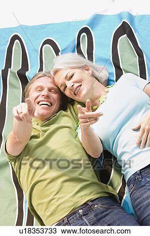 Couple laying on blanket View Large Photo Image Stock Image - Couple laying on blanket. Fotosearch