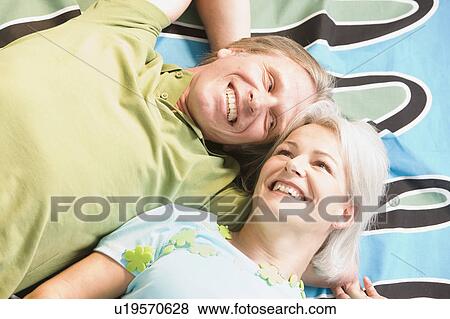 Stock Photo - Couple laying on blanket. Fotosearch
