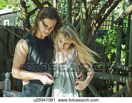 Couple listening to music together View Large Photo Image Stock Image - Couple listening to music together. Fotosearch