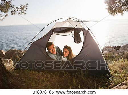 Couple lying in tent by sea View Large Photo Image Stock Photography - Couple lying in tent by sea. Fotosearch