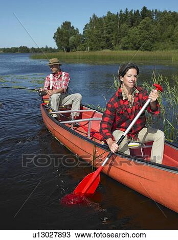 Stock Image - Couple on a canoe. Fotosearch