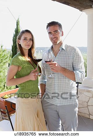 Couple on hotel patio toasting with wine View Large Photo Image Stock Photography - Couple on hotel patio toasting with wine. Fotosearch