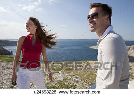 Couple overlooking sea View Large Photo Image Stock Photo - Couple overlooking sea. Fotosearch