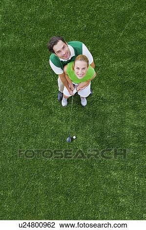 Couple playing golf View Large Photo Image Stock Image - Couple playing golf. Fotosearch