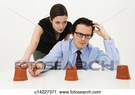 Stock Image - Couple ponder location of hidden item. Fotosearch