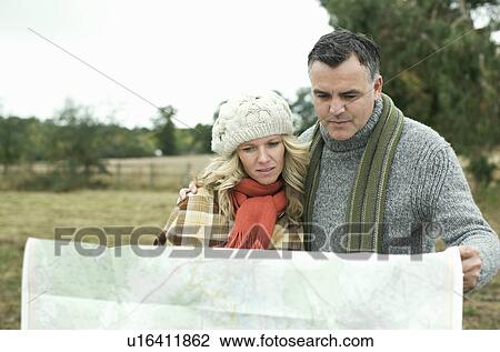 Stock Image - Couple reading map. Fotosearch