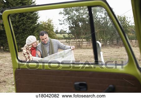 Stock Image - Couple reading map. Fotosearch