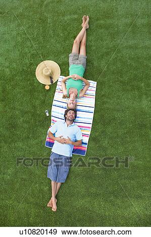Couple resting in a garden View Large Photo Image Stock Photo - Couple resting in a garden. Fotosearch