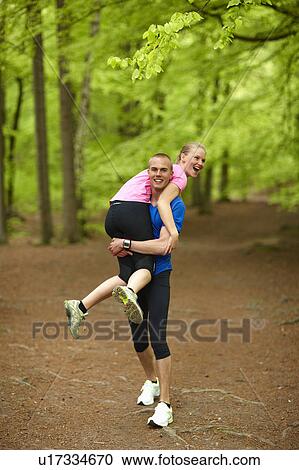 Couple running in forest, having fun View Large Photo Image Stock Image - Couple running in forest, having fun. Fotosearch