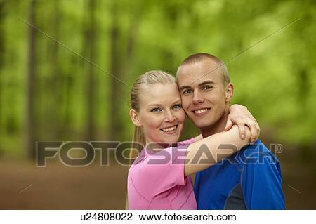 Stock Image - Couple running, standing together. Fotosearch