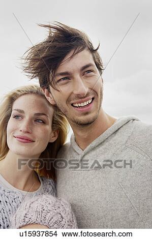 Couple smiling on beach View Large Photo Image Picture - Couple smiling on beach. Fotosearch