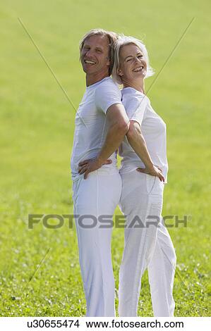 Couple standing back to back View Large Photo Image Picture - Couple standing back to back. Fotosearch