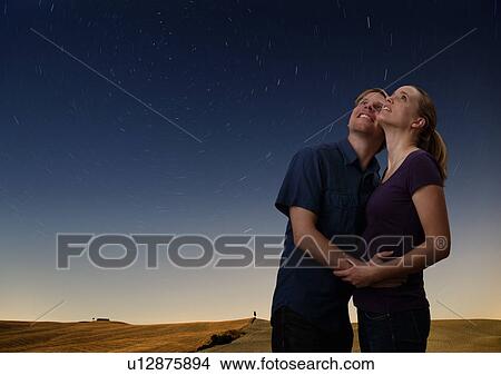 Picture - couple watching the starry night sky. Fotosearch