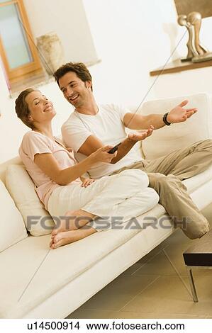 Couple watching tv View Large Photo Image Picture - Couple watching tv. Fotosearch